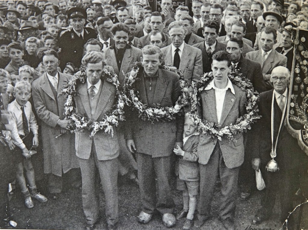 : De winnaars van de Bond in 1956. V.l.n.r.: Sikke Bouwma, Wijtse Vlietstra en Corrie Hoekstra. Met geheel rechts de pake van Wijtse Vlietstra als afgevaardigde van Jan Bogtstra.